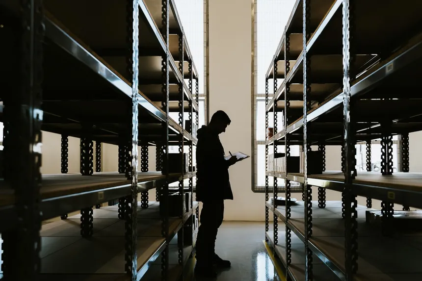 Inspector checking finished goods against specification